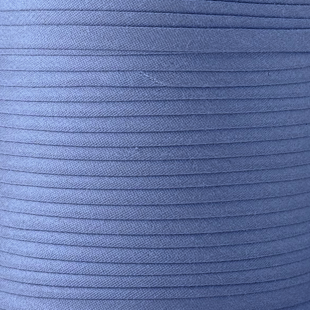 color swatch of the denim blue 1" no gap single fold bias tape on a roll from Heit's Wholesale bulk sewing supply company