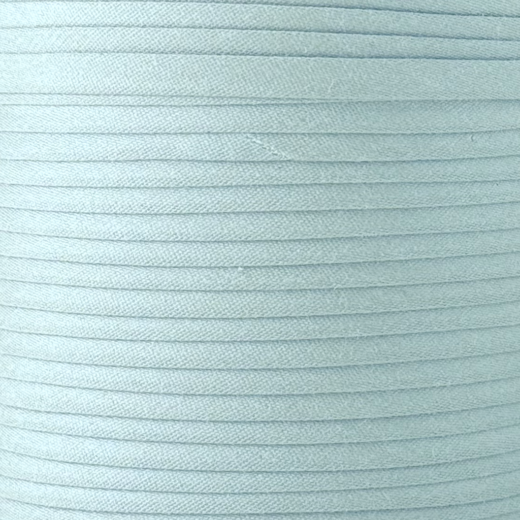 color swatch of the frost blue 1/4" double fold bias tape on a spool from Heit's Wholesale bulk sewing supply company