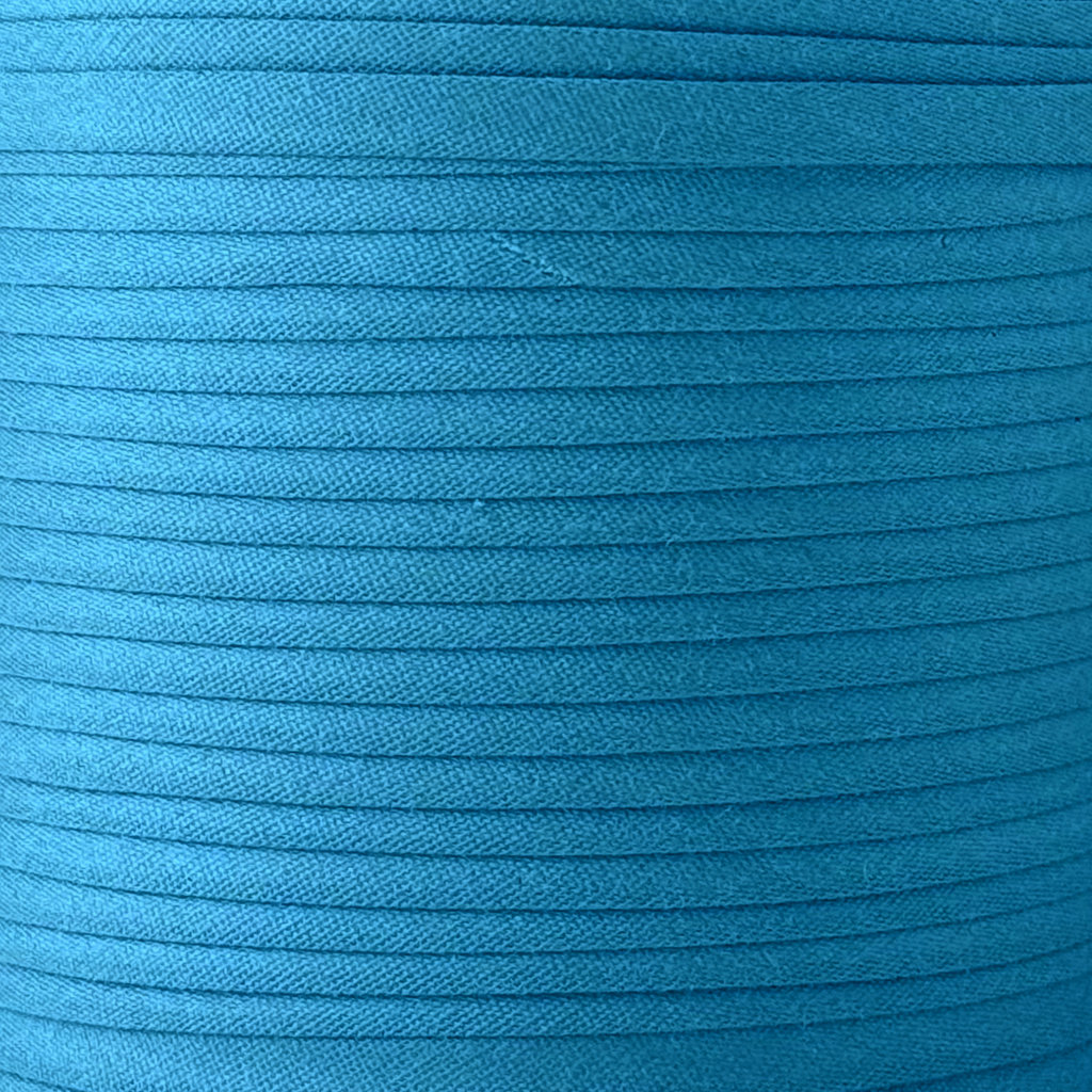 color swatch of the miami blue 1/4" double fold bias tape on a spool from Heit's Wholesale bulk sewing supply company