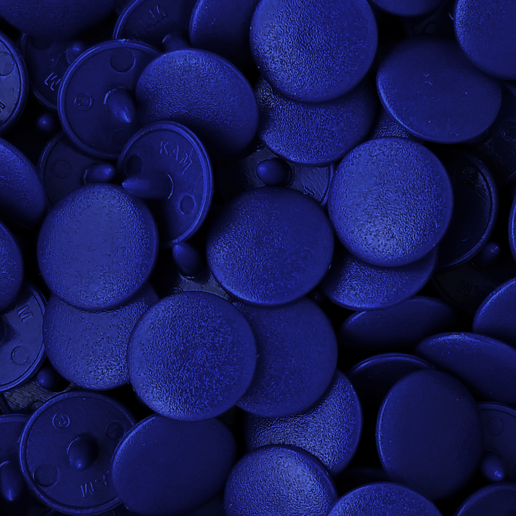 close up of the light navy size 16 poly resin snaps for children's clothing sold at Heit's Wholesale bulks sewing supply company