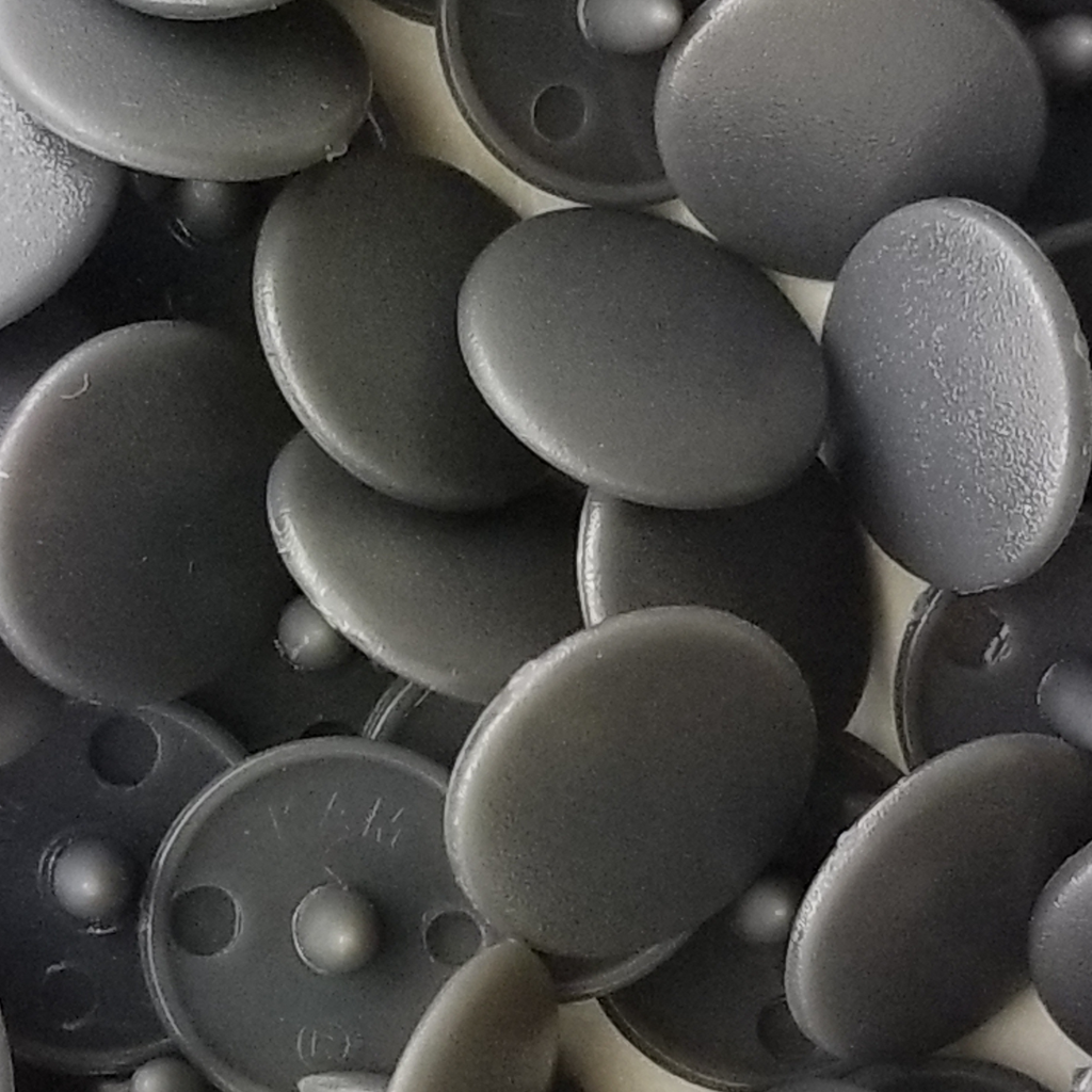 close up of the dark gray size 20 poly resin snaps with a matte finish from Heit's Wholesale bulk sewing supply company 