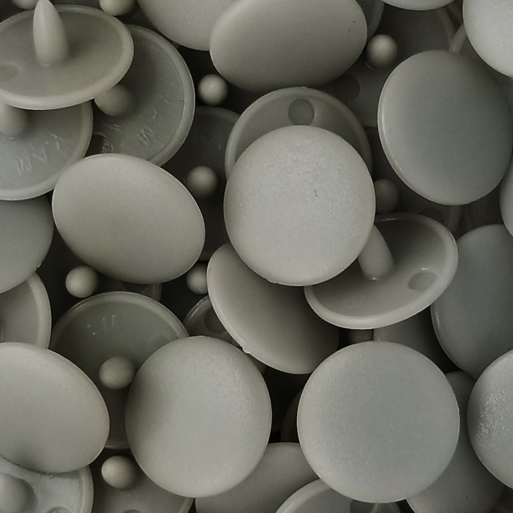 group of the light gray size 20 poly resin snaps with a matte finish from Heit's Wholesale bulk sewing supply company 