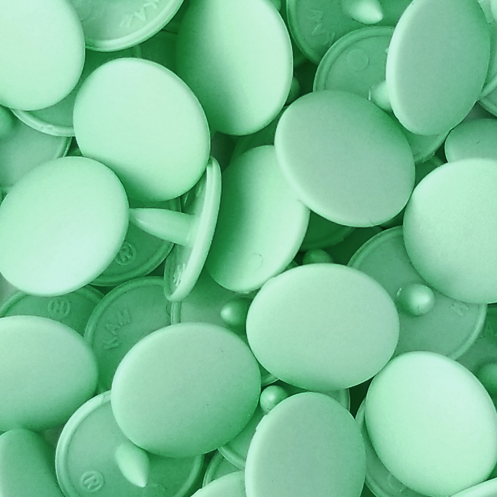 close up of the mint size 20 poly resin snaps with a matte finish from Heit's Wholesale bulk sewing supply company 