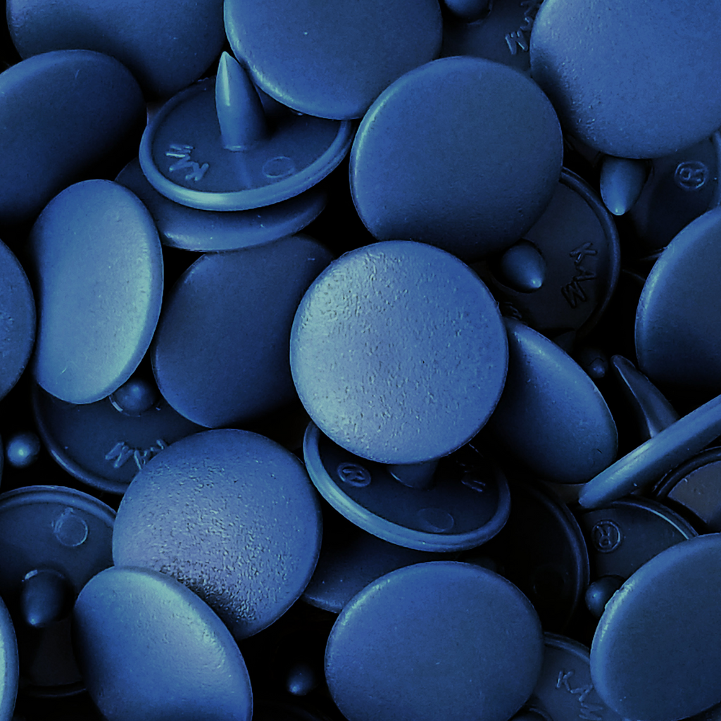 close up of the turquoise size 20 poly resin snaps with a matte finish from Heit's Wholesale bulk sewing supply company 